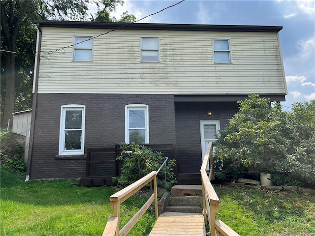 rear view of house featuring a yard