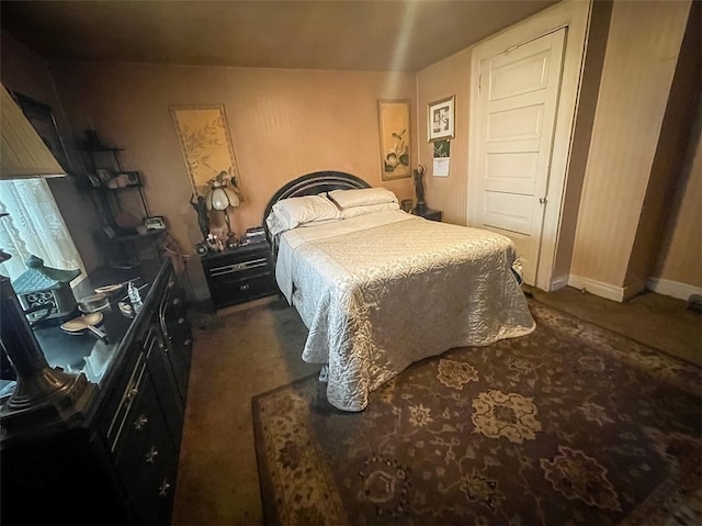 bedroom featuring dark carpet