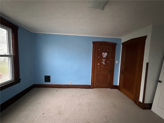 foyer entrance with carpet