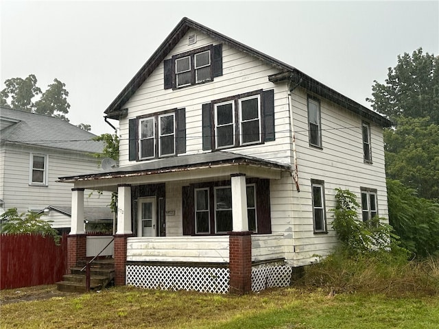 view of front of home featuring a porch and a front lawn