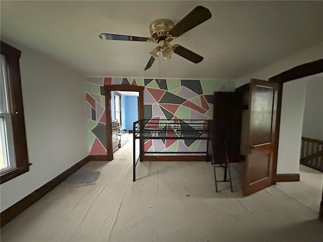 unfurnished bedroom featuring ceiling fan