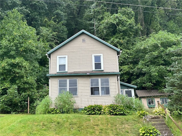 view of side of home with a yard