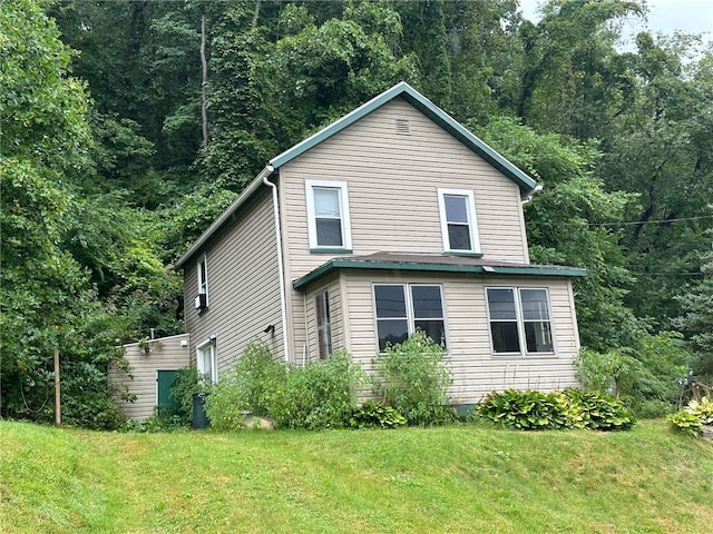 view of side of home featuring a lawn