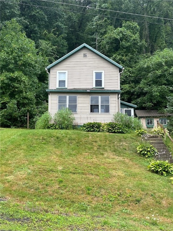 view of side of property with a lawn