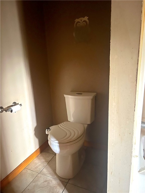 bathroom with toilet and tile patterned flooring