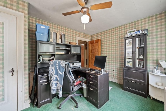 carpeted office space featuring wallpapered walls and a ceiling fan