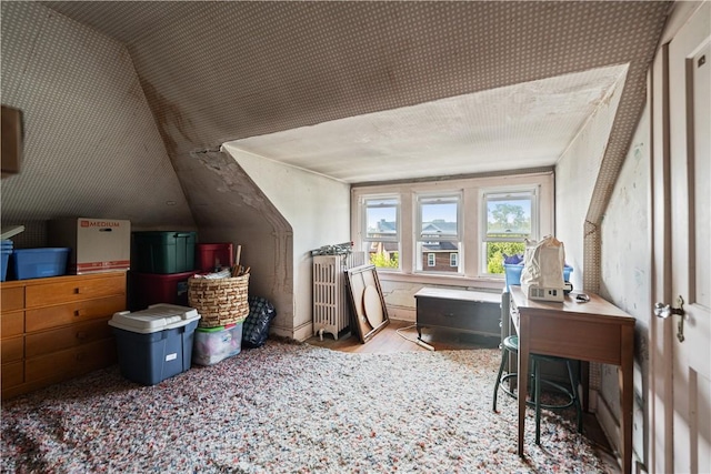 additional living space featuring lofted ceiling and wood finished floors