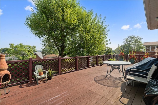 wooden deck featuring outdoor dining area