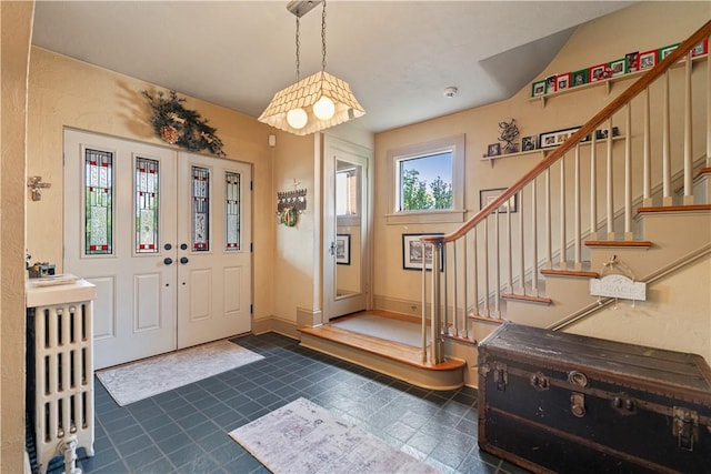 foyer with stairs and baseboards