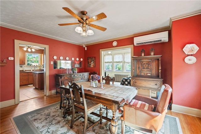 dining area featuring crown molding, a healthy amount of sunlight, light wood-type flooring, and a wall mounted AC