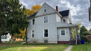 rear view of house with a yard