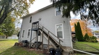 rear view of house with a yard