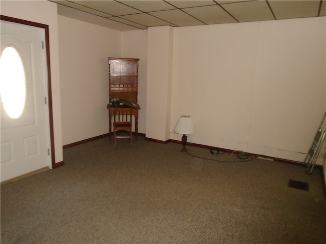 entrance foyer featuring a paneled ceiling and carpet