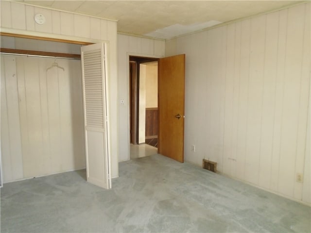 unfurnished bedroom featuring a closet and carpet