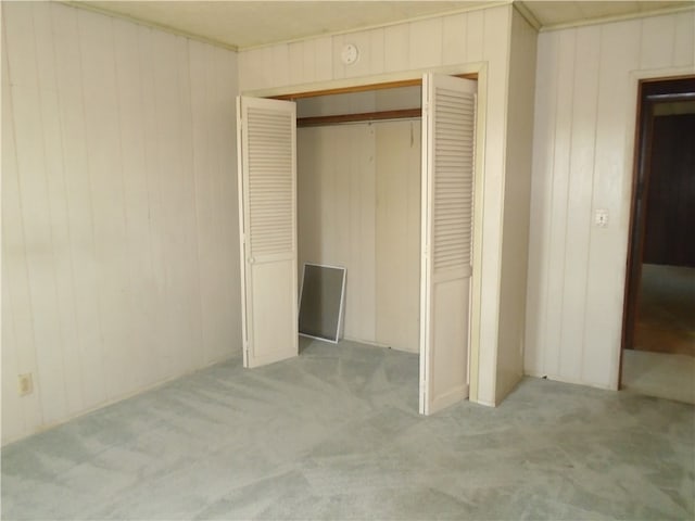 unfurnished bedroom featuring carpet and a closet