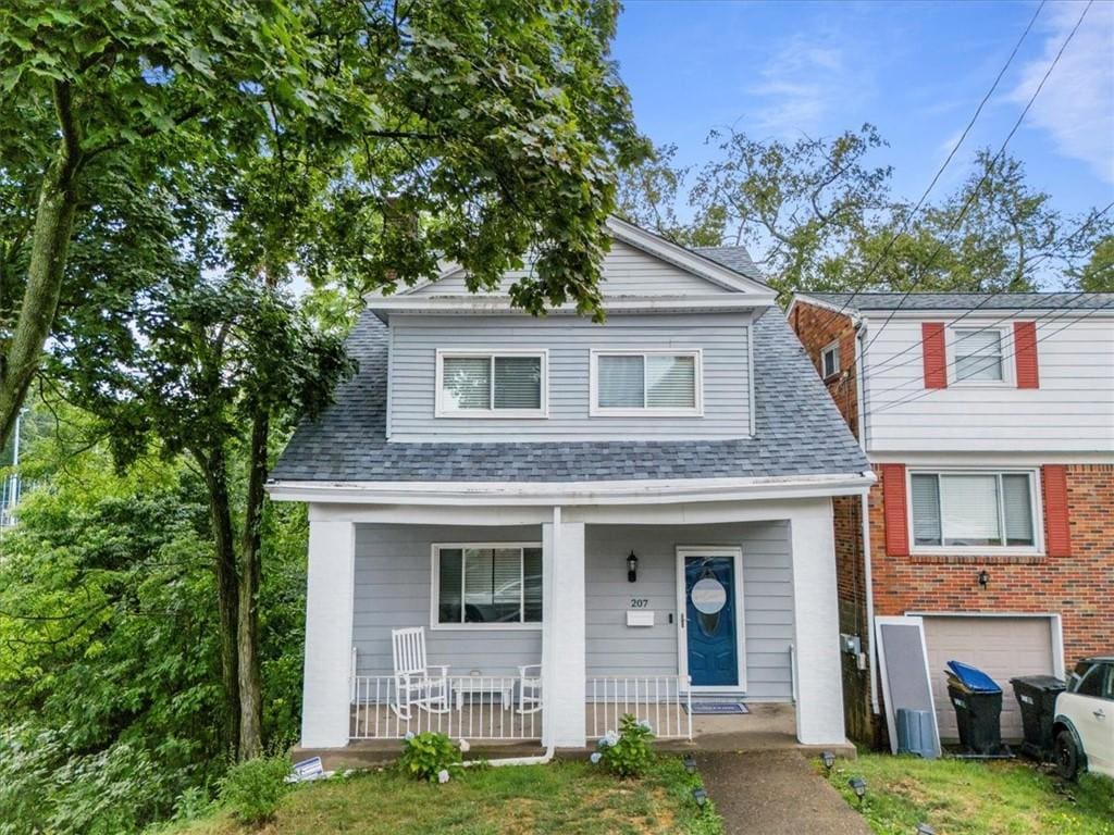 view of front of property with a garage and covered porch