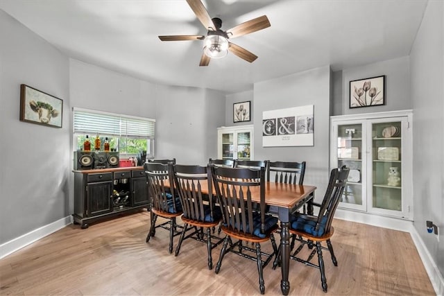 dining room with ceiling fan and light wood-type flooring