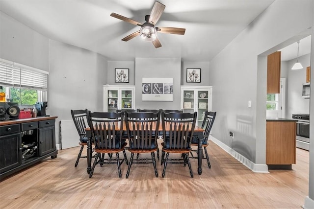 dining room with ceiling fan and light wood-type flooring