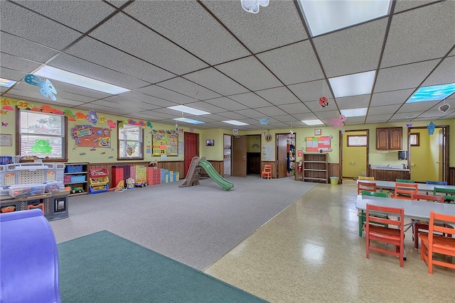 rec room with a paneled ceiling