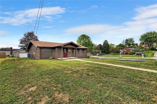 view of front of house featuring a garage, a front yard, central AC unit, and brick siding