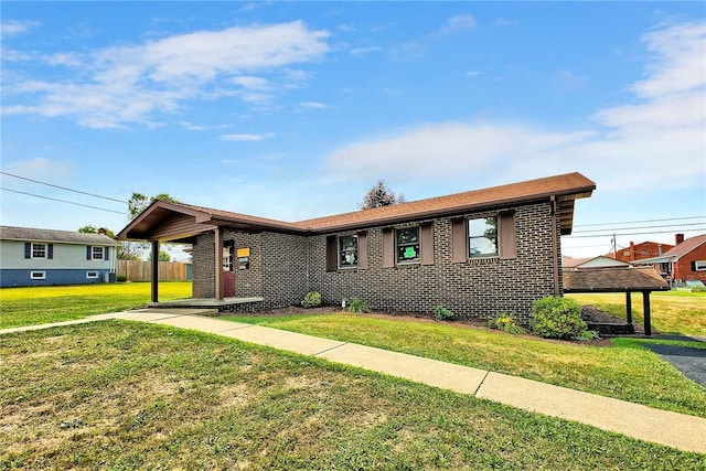 ranch-style home featuring brick siding and a front yard