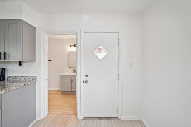 foyer with light hardwood / wood-style floors and sink