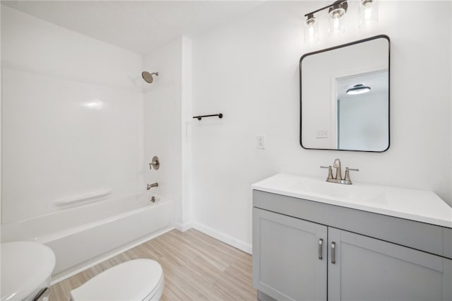 full bathroom featuring shower / washtub combination, toilet, vanity, and hardwood / wood-style floors