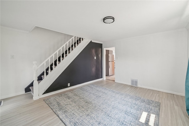 unfurnished room featuring light hardwood / wood-style floors and ornamental molding