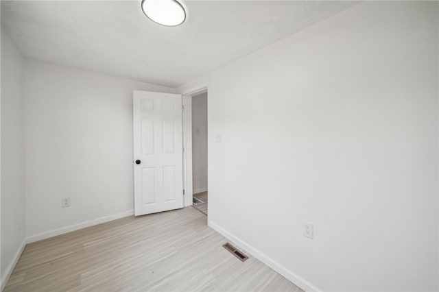 spare room featuring light hardwood / wood-style flooring