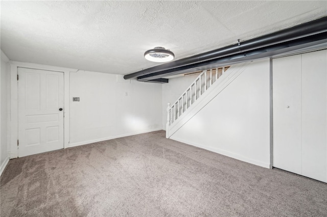 basement with carpet flooring and a textured ceiling