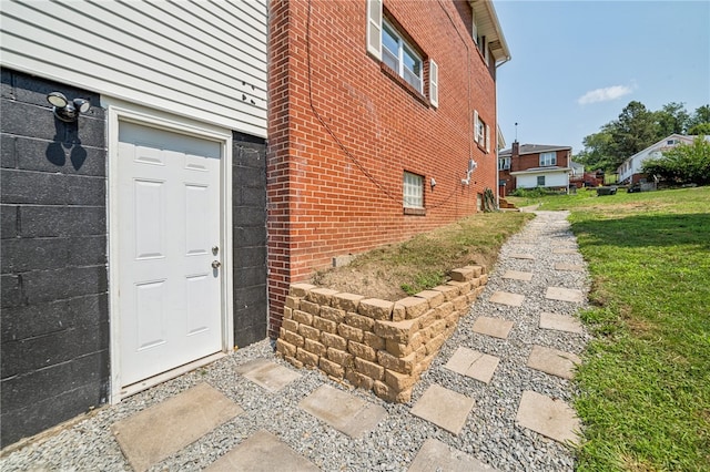 doorway to property with a yard