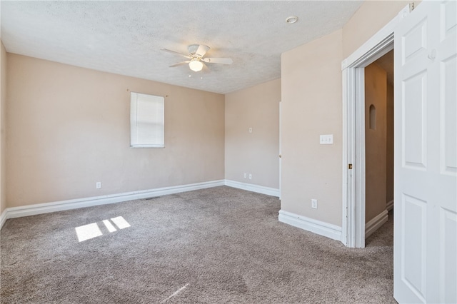 carpeted spare room with a textured ceiling and ceiling fan