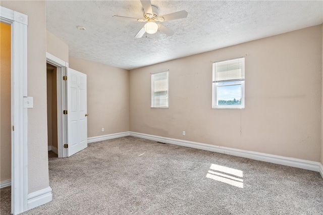 unfurnished room with light carpet, a textured ceiling, and ceiling fan