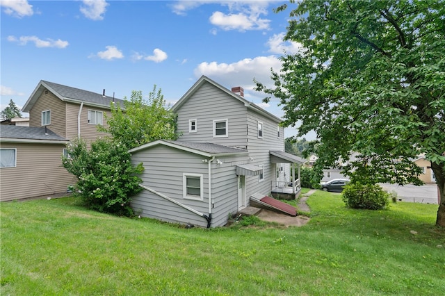 back of property featuring a lawn