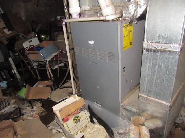 utility room featuring heating unit