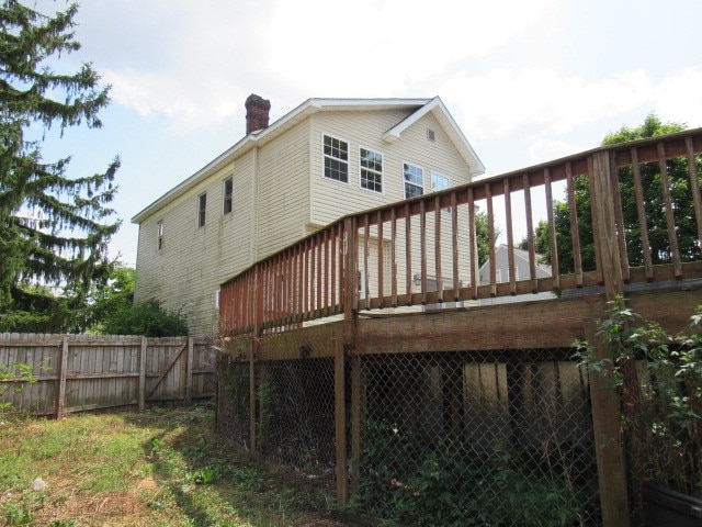 back of property with a wooden deck