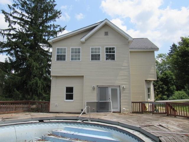 back of property featuring a swimming pool side deck