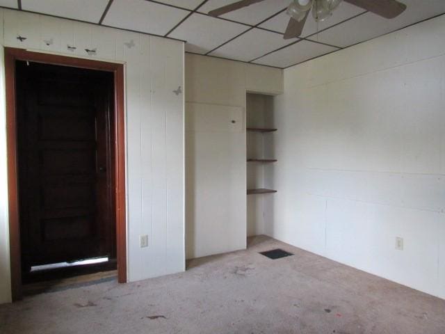 interior space with light colored carpet and a paneled ceiling