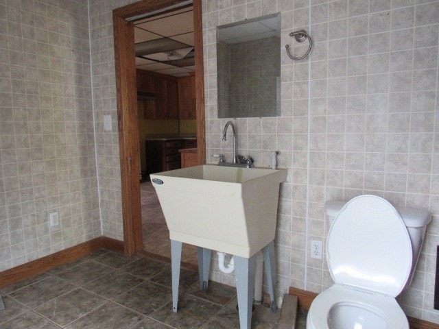 bathroom featuring tile walls, toilet, and tile patterned floors