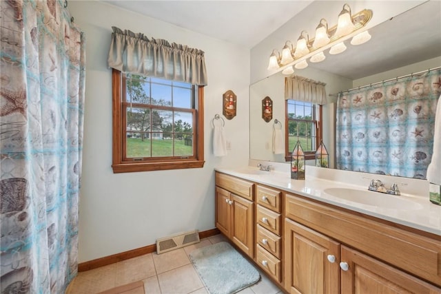 bathroom with a shower with shower curtain, vanity, tile patterned floors, and plenty of natural light