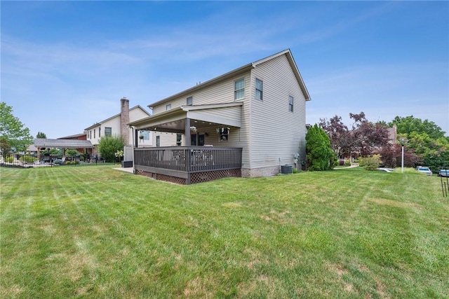 back of property with a yard and central AC unit