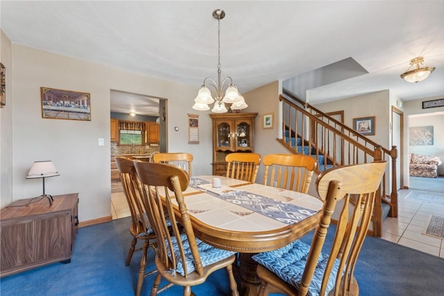 dining space featuring carpet flooring and an inviting chandelier