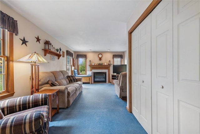 carpeted living room featuring a tile fireplace