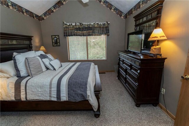 bedroom featuring carpet and vaulted ceiling