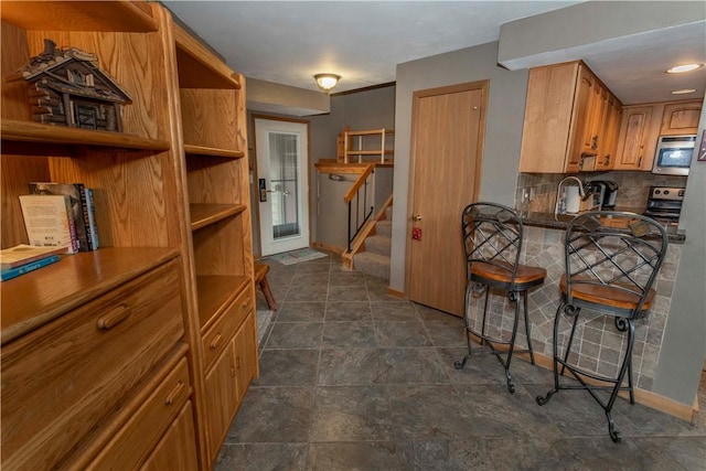 kitchen featuring appliances with stainless steel finishes and tasteful backsplash