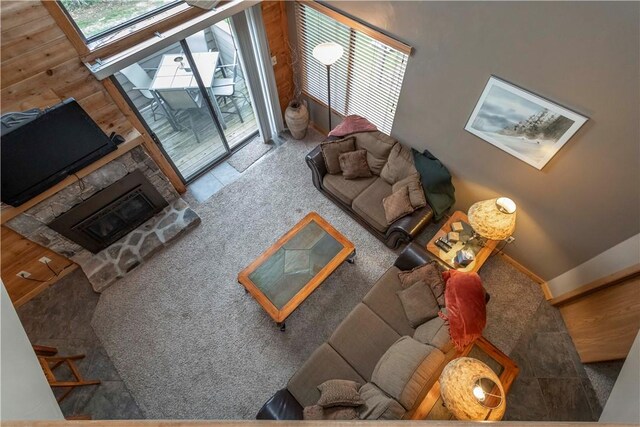 living room featuring a stone fireplace