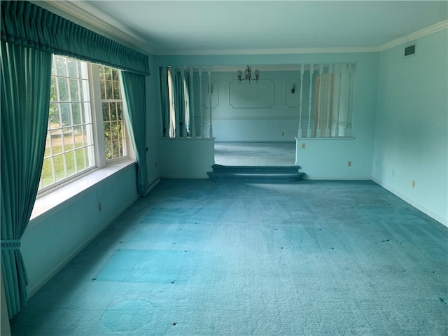 spare room with carpet, a chandelier, and ornamental molding