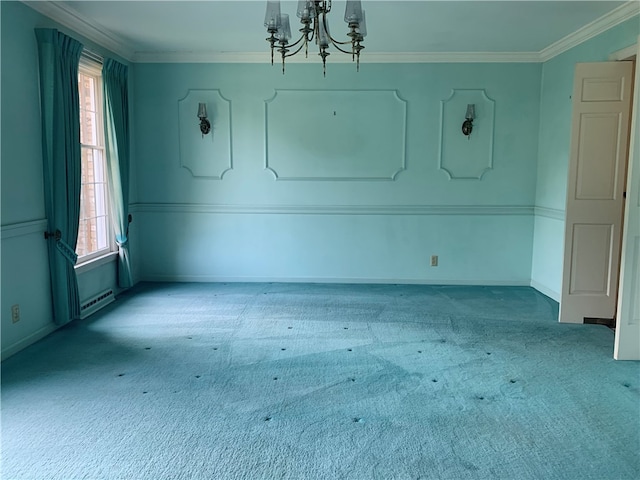 carpeted spare room featuring a chandelier and ornamental molding