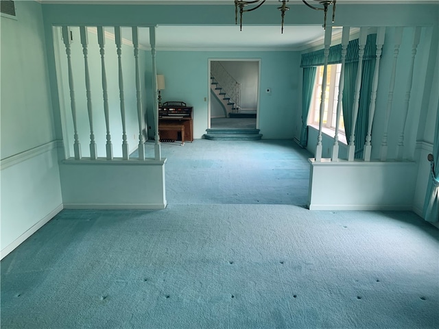 spare room featuring crown molding and carpet flooring