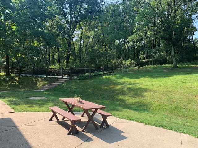 view of home's community featuring a patio area and a lawn